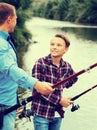 Father and son fishing together on lake Royalty Free Stock Photo