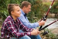Father and son fishing together on lake Royalty Free Stock Photo