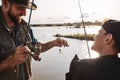 Father and son fishing together on sunny day Royalty Free Stock Photo