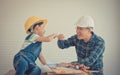 Father and Son fist bump success concept in construction industry concept in vintage tone