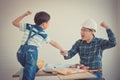 Father Son fist bump for success concept in construction industry concept in vintage tone