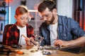 Father with son fixing broken details from laptop