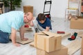 A father and son review how to assemble a new bookcase. Royalty Free Stock Photo