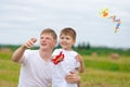 Father and son fly a kite together in summer Royalty Free Stock Photo