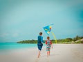 Father and son flying kite on beach, family vacation Royalty Free Stock Photo