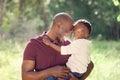 Father, son and forehead touch in outdoor for love, affection and support in nature to connect. Black family, trust and Royalty Free Stock Photo