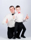 Father and son formal clothes outfit. Grow up gentleman. Dad and boy white shirts with bow ties. Gentleman upbringing Royalty Free Stock Photo