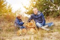 Father and son with full basket of mushrooms rest in forest Royalty Free Stock Photo