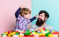 Father son game. Father and son create constructions. Bearded man and son play together. Surefire ways to bond with your Royalty Free Stock Photo