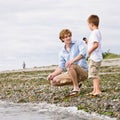 Father and son gathering rocks at beach Royalty Free Stock Photo