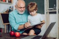 Father and son - generation people concept. Kid with old teacher learning in class on background of blackboard. Little Royalty Free Stock Photo