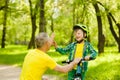 Father and son give high five while cycling in the park Royalty Free Stock Photo