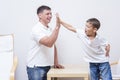Father and Son Are Giving a High Five to Each Other Royalty Free Stock Photo