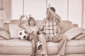 Father and son giving high-five while watching soccer match Royalty Free Stock Photo