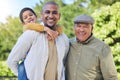 Father, son and grandfather with generations in park portrait with piggy back, happiness or love on vacation. Men, boy Royalty Free Stock Photo