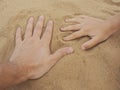 Father and son hands on sand. Close up Royalty Free Stock Photo