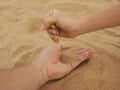 Father and son hands on sand. Close up Royalty Free Stock Photo