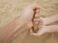 Father and son hands on sand. Close up Royalty Free Stock Photo