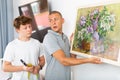 Father and son hang picture together on the wall of house Royalty Free Stock Photo