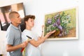 Father and son hang picture together on the wall of house Royalty Free Stock Photo