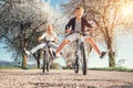 Father and son have a fun when riding bicycles on country road with blossom trees Royalty Free Stock Photo