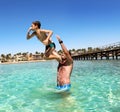 Father and son have fun at sea.