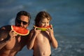 Father and son have fun in summer sea. Fathers day. Father and son rest an beach, summer family. Child with dad eat Royalty Free Stock Photo