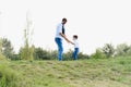 Father and son have fun together in nature. Father and son playing. People having fun outdoors. Concept of friendly family