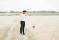 Father and son have a rest in the wheat field at the day time. People relaxing outdoors