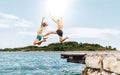 Father and son having a fun on a merry vacation days on Adriatic sea coast. They dressed swimming trunks jumping to the waives Royalty Free Stock Photo