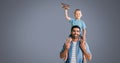 Father and son having fun playing with grey background Royalty Free Stock Photo