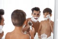 Father and son having fun while shaving Royalty Free Stock Photo