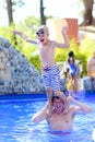Father and son having fun in swimming pool