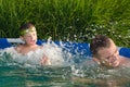 Father and son having fun in the swimming pool Royalty Free Stock Photo