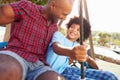 Father And Son Having Fun On Swing In Playground Royalty Free Stock Photo