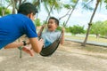 Father and son having funny on swing in playground Royalty Free Stock Photo