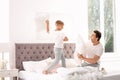 Father and son having pillow fight on bed Royalty Free Stock Photo