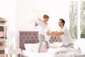 Father and son having pillow fight on bed Royalty Free Stock Photo