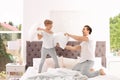 Father and son having pillow fight Royalty Free Stock Photo