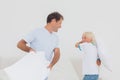 Father and son having a pillow fight Royalty Free Stock Photo