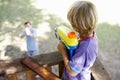 Father And Son Having Water Pistol Fight In Tree House Royalty Free Stock Photo