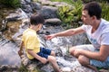 Father and son hikers  tourists on the background of Amazing Waterfall. Active leisure time with children concept Royalty Free Stock Photo