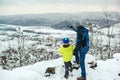 Father and son hiking in winter mountains. Child looking through monoculars on the snowy slopes of mountains Royalty Free Stock Photo