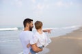 Father with son in his arms walking on a tropical beach Royalty Free Stock Photo