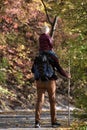 Father with son on his shoulders walking in the autumn forest. Back view Royalty Free Stock Photo