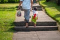 Father and son hold hands and climb the stairs. Indonesian culture. island of Bali. Close up