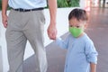 Father and son holding hand, Cute little Asian 2 - 3 years year toddler baby boy child wearing protective medical mask