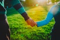 Father and son holding hands at sunset, parenting Royalty Free Stock Photo