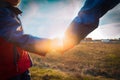 Father and son holding hands at sunset, parenting