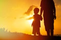 Father and son holding hands at sunset sea Royalty Free Stock Photo